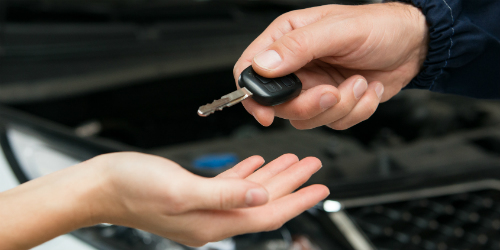 Car Key being handed to another person